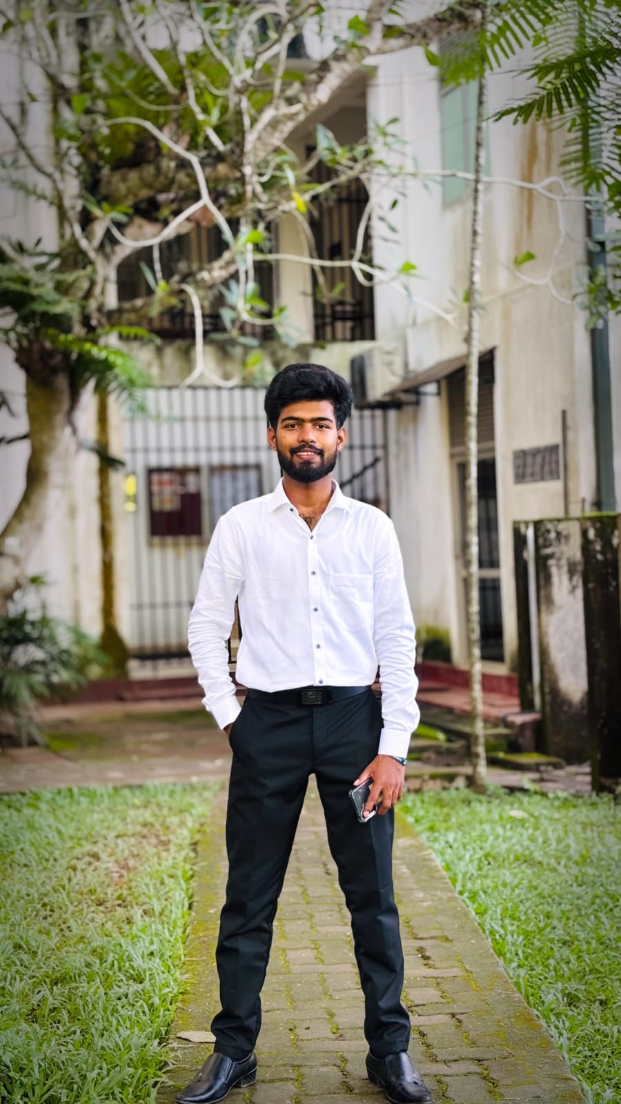 Portrait of Selvanathan Rakukaran, Commitee member of the Tamil Student Association, smiling and wearing formal attire, standing in a university or event setting. If visible, text in the image: Selvanathan Rakukaran Commitee member. The atmosphere is welcoming and professional.