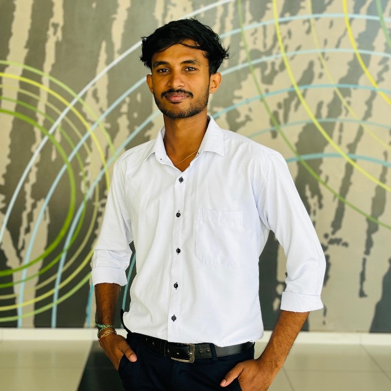Portrait of Pirabakaran Shakiththiyan, 4th year Committee Member of the Tamil Student Association, smiling and wearing formal attire, standing in a university or event setting. If visible, text in the image: Pirabakaran Shakiththiyan 4th year Committee Member. The atmosphere is welcoming and professional.